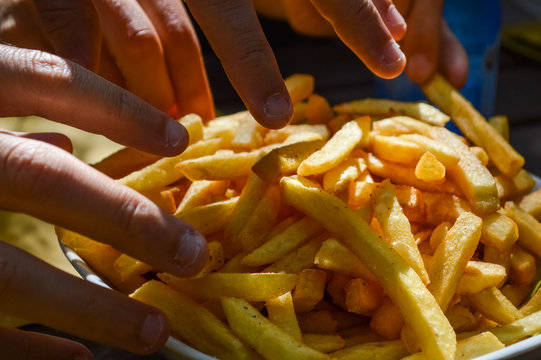 Sharing French Fries - Close Up On Fingers Picking