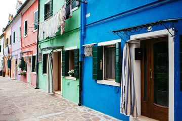 Fototapeta na wymiar Colorful houses taken on Burano island , Venice, Italy in summer time. Positive color makes beautiful background