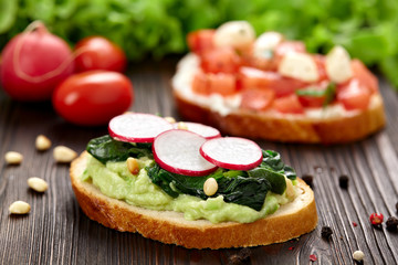 Delicious sandwiches with soft cream cheese and radish. Vegetarian food.