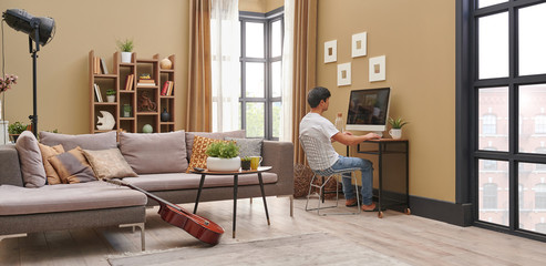 Man at home and working style. Brown living room concept, television spend time.