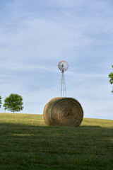 bale of hay and wind mill
