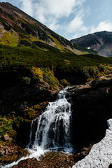 Waterfall in the mountain range. Kamchatka