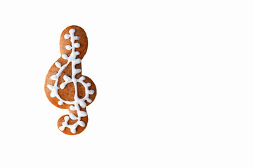 Gingerbread treble clef isolated on white background, copy space for text