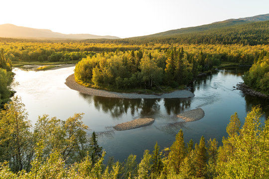 Sunset at a horseshoe bend in a river in the wilderness of Jamtland, Sweden.
