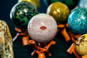 Stone in Sphere shape with a mark like lips on the stand. Various stones minerals gems. Natural...