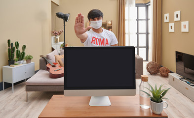 Close up computer screen and corona virus warning, man at home interior concept.