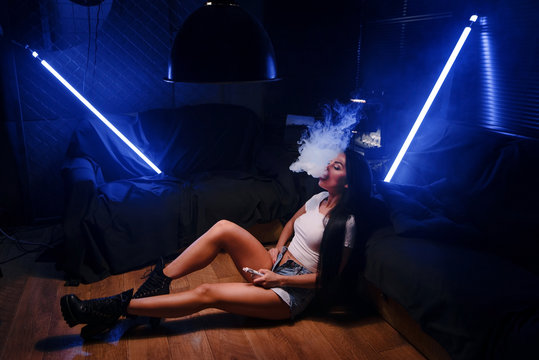 sexy brunette woman smoking electronic cigarette