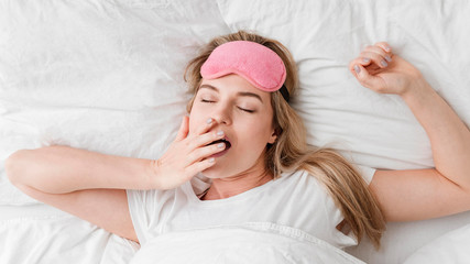 Fototapeta premium Woman yawning and being sleepy