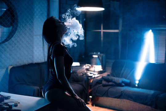 sexy brunette woman smoking electronic cigarette