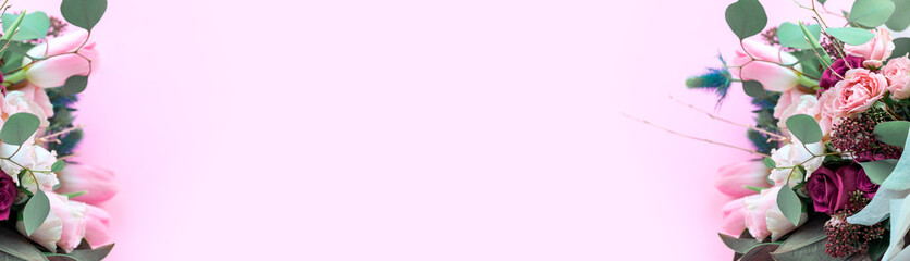 A closeup bouquet of roses and tulips decorated with leaves and twigs of other beautiful plants. Holiday concept. Flowers for Mother's Day. Copy space.