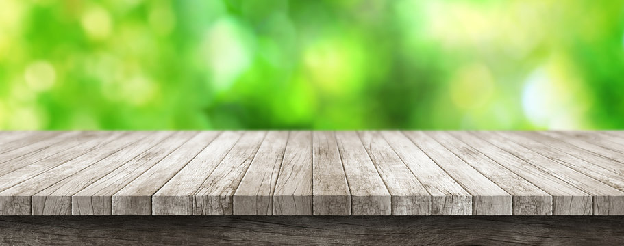 Wooden Table Top With Blurry Green Background