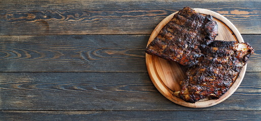 Roasted pork ribs on a rustic wooden table