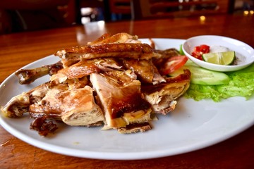 Grilled chicken with vegetables at Vietnamese restaurant.