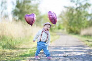 niedliches Mädchen draußen im Park, Luftballons