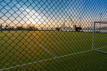 Digital composition of soccer field and blue sky