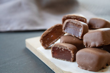Turkish sweets (Turkish delight) in chocolate on a gray background