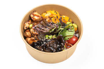 Poke bowl with chicken and vegetables on the white table.