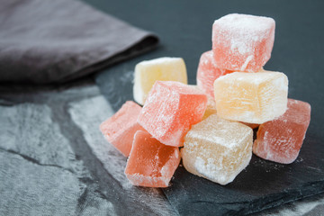 Turkish sweets (Turkish delight) of different colors in powdered sugar