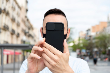 man wearing mask taking selfie or doing video call