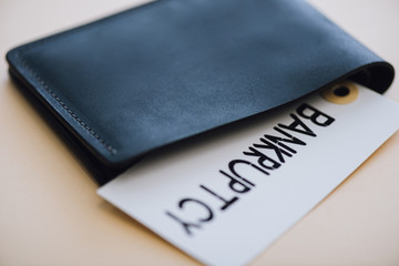 Black purse and card with bankruptcy lettering on white