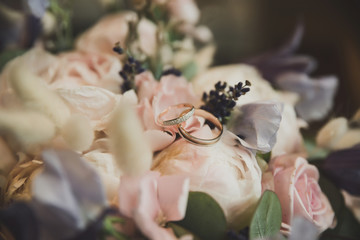 wedding rings on the bride's bouquet