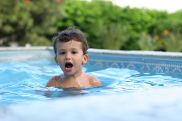 boy playing in the pool, narrow focus