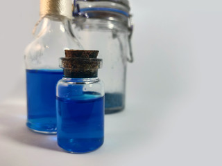 Potions with blue liquid. Alchemy set with flasks. small glass bottles with colored liquid for game...