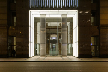 Well lit lobby of large business skyscraper in downtown Chicago at night - 348543898