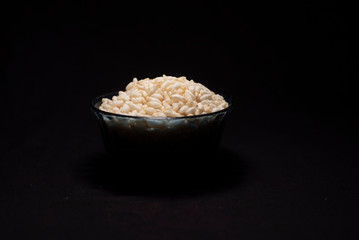 A bowl of puffed rice in a dark copy space background. Food and product photography.