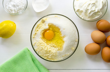 Step by step recipe of cheesecake. Flour mixture with egg and sugar in a bowl