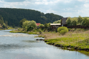 Fototapeta na wymiar Rural landscape with river and house