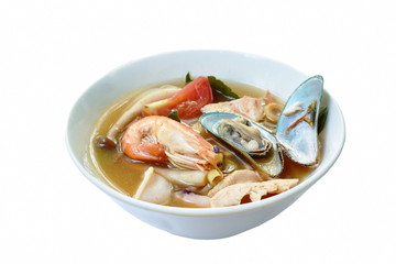 boiled shrimp and chicken with mussel in Thai spicy tom yum soup on bowl