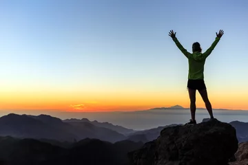 Foto auf Acrylglas Kanarische Inseln Woman climber success silhouette in mountains, achievement inspiration