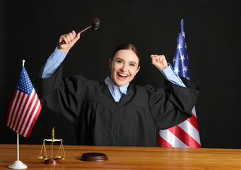 Happy female judge at table in courtroom