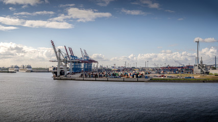 Container terminal in sunny weather with 2 cruise ships in Hamburg 