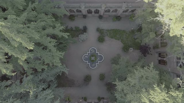 Aerial Drone Top-Down Zenithal view of inside historical palace courtyard, Spanish Patio with fountain and garden