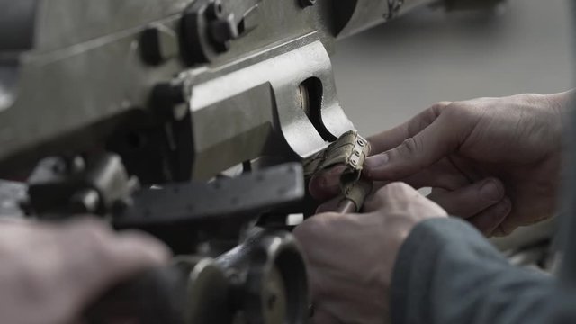 Loading a Schwarzlose machine gun with ammunition. 4K stock footage.