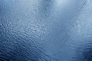 Waves on lake water from top.