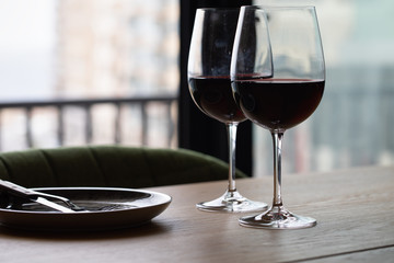 Luxury red wine. Delicious drinks, made from delicious grapes in wine glass on the table. restaurant close up. red wine on table. plate with wine on table. restaurant open. catering industry