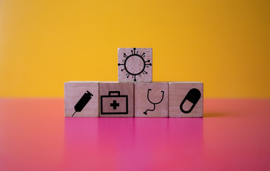 wood cube with a medical symbol  angle Flat lay,Concept: Health insurance family covid-2019 epidemic, management protect healthcare to a virus, care service doctor treatment for hospital