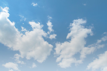 Tropical summer bright blue sky background with white puffy fluffy cumulus clouds & cotton candy cloudscape in beautiful warm weather & sunny morning sunlight on daylight horizon at sunshine day   