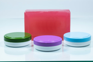 Hand soap and hand cream in 3 different colors close-up. White in the background. Close up.