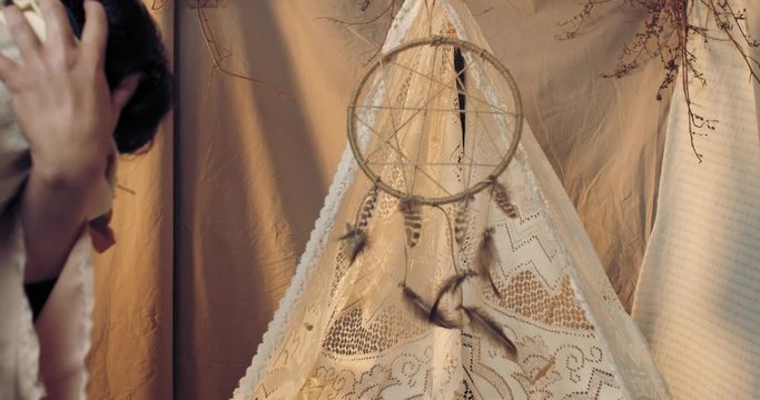 Woman is rocking her baby and putting it into the cradle, native american, 4k