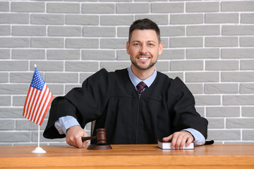 Male judge at table in courtroom