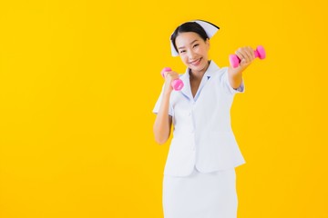 Portrait beautiful young asian woman thai nurse with dumbbell