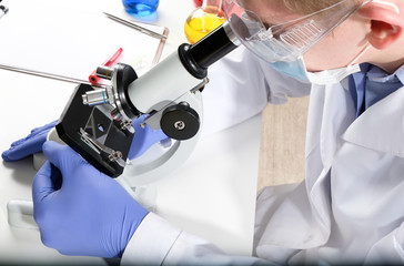 Scientist works with a microscope.