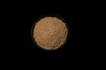 A bowl of Indian pulses in a dark copy space background. Food and product photography.