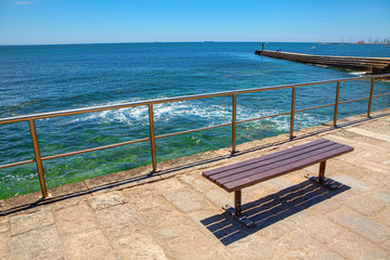 Fototapeta na wymiar empty bench at the sunny seaside