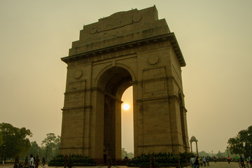 Fototapeta na wymiar Sunrise at India Gate, New Delhi / Morning Cycling | Silhouette of India Gate, Vijay Chowk, Sun behind India Gate/ Empty India Gate, War Memorial