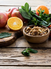 Colorful summer sweet salad with spinach, orange, cherry tomatoes, walnut, figs, quinoa, fresh fruit